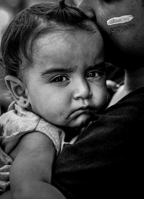 Free Grayscale Photo of Baby on a Mother's Arms Stock Photo