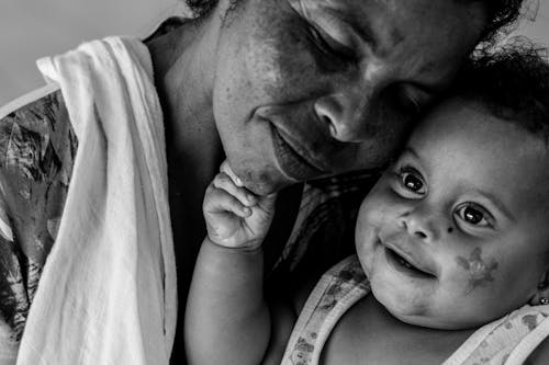 Free Monochrome Photo of Mother leaning her Head on her Child Stock Photo