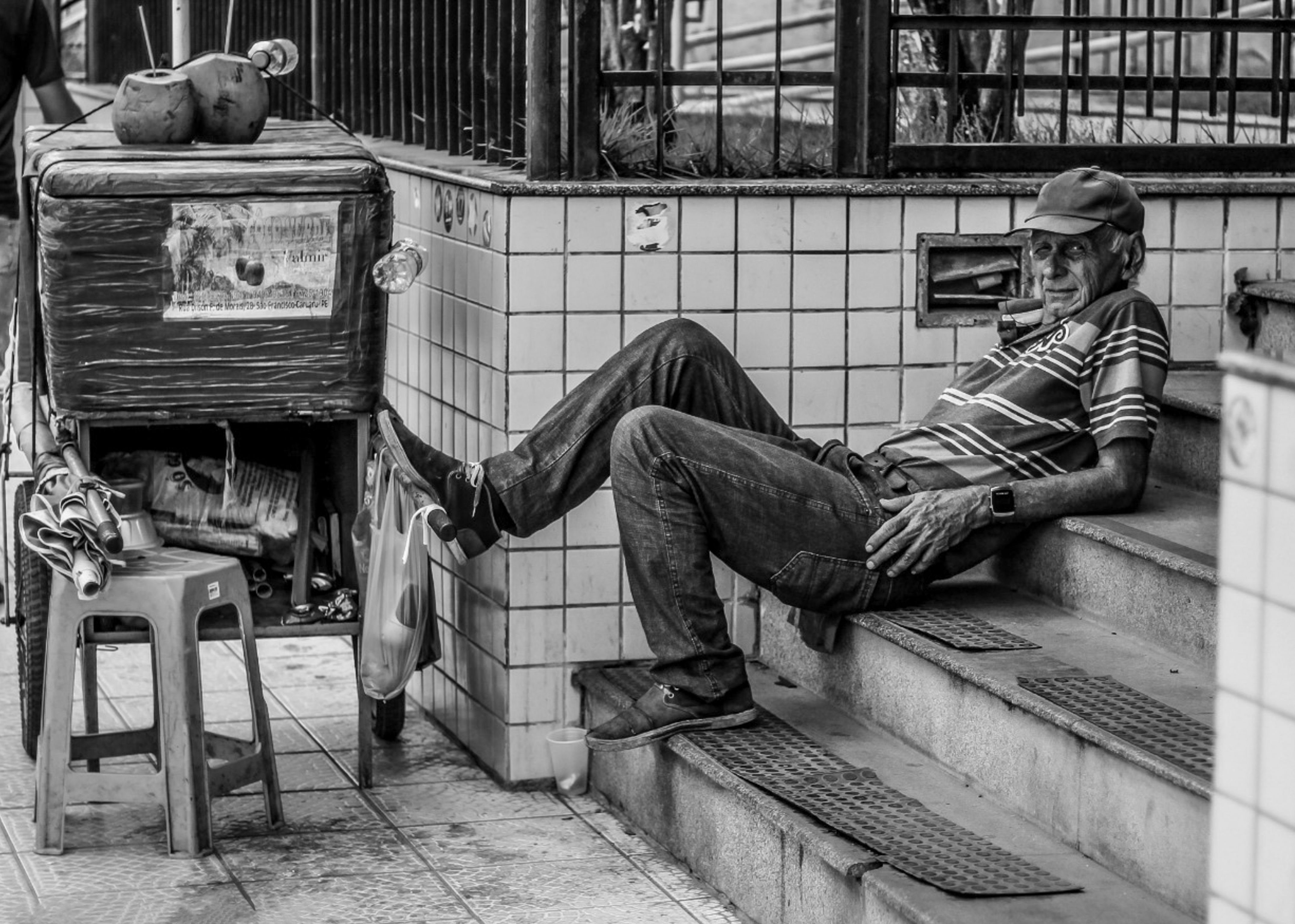 Grayscale Photo of a Man Sitting on Concrete Stairs · Free Stock Photo