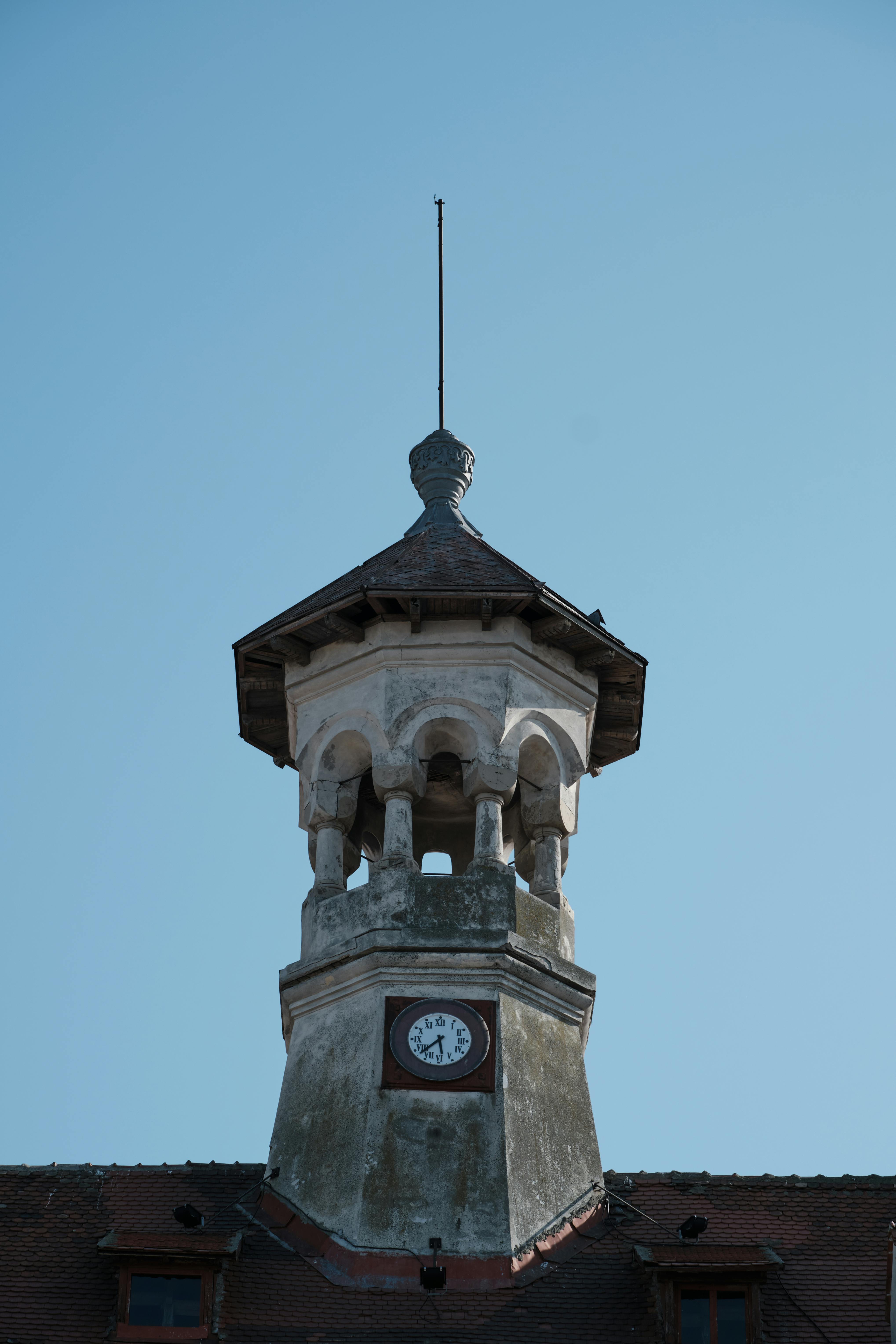 A close-up shot of a beautifully restored antique clock, now functioning as a modern desk clock, with Auckland city skyline in the background.