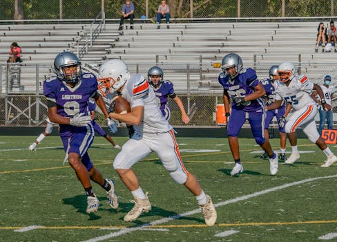 Intense high school football game in Columbia, MD with athletes in action.