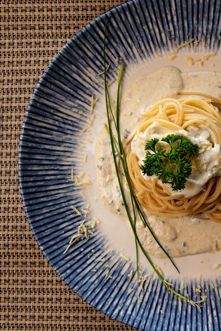 Top View Of A Pasta Dish On A Blue And White Plate