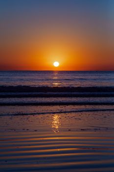 Captivating sunset reflecting on the ocean in Balneário Camboriú, Brazil.
