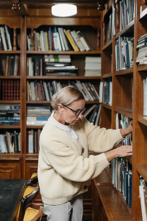 A Man Browsing at the Library · Free Stock Photo