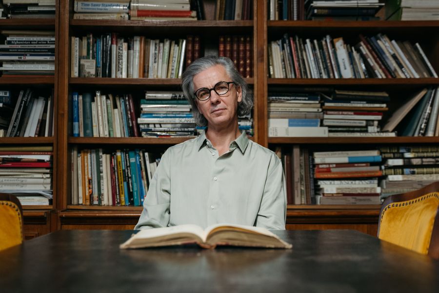 Man with eyeglasses reading in a library by Tima Miroshnichenko on Pexels