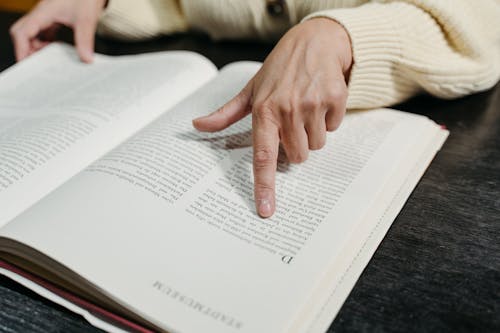 Free A Person Reading a Book Stock Photo