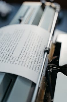 Close-up of a vintage typewriter and paper showing typed text in an artistic setting.