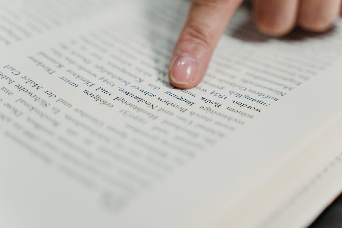 Person doing focused language study with notebook and pen