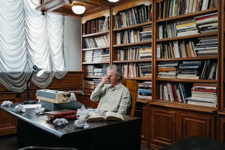 A Man Sitting Behind His Desk