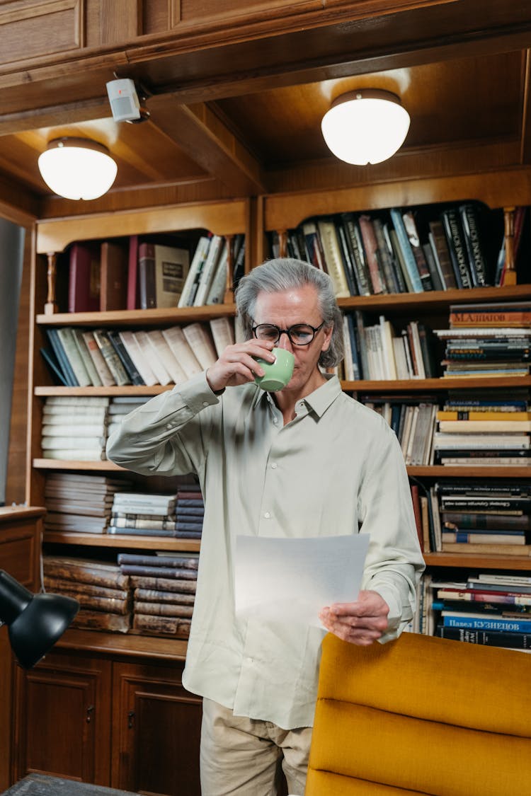 A Man Drinking Coffee In A Cup