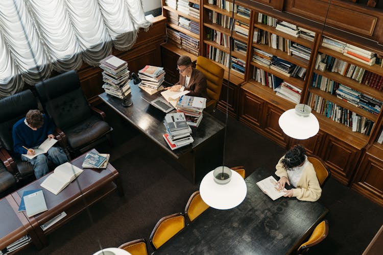 People Reading Inside A Library