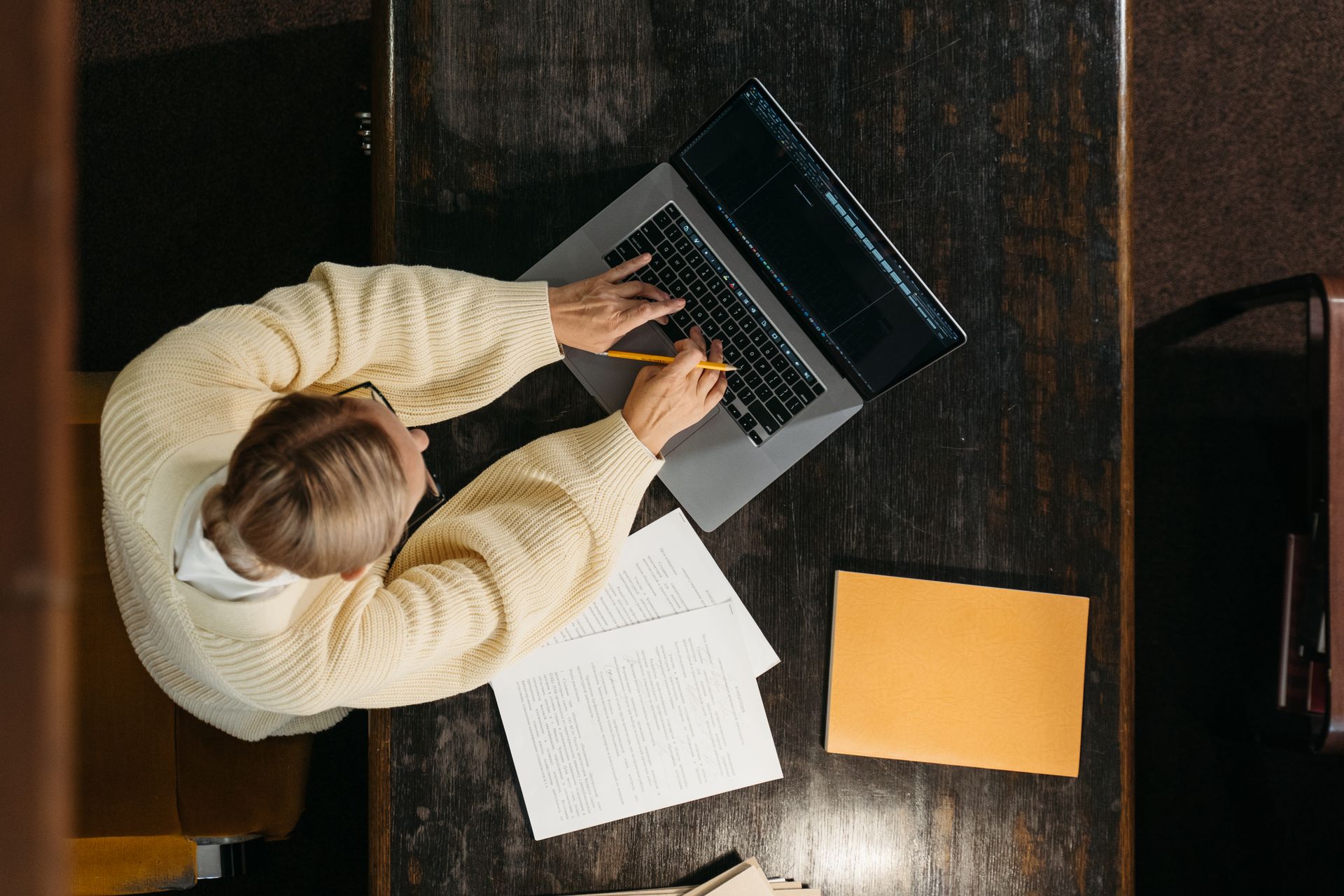 High-Angle Shot of a Person Using a Laptop