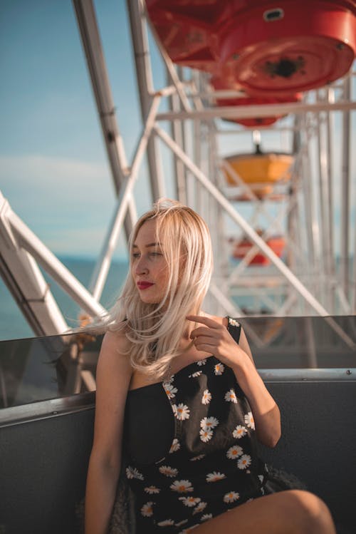 Woman Sitting on a Ferris Wheel