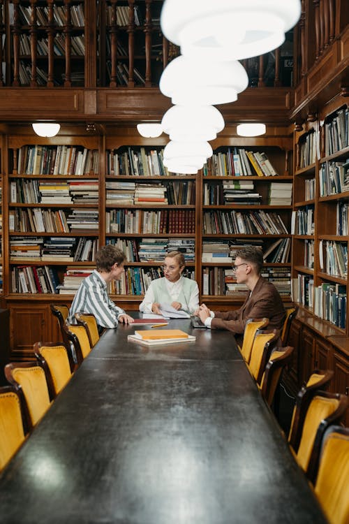 People Studying in the Library Together