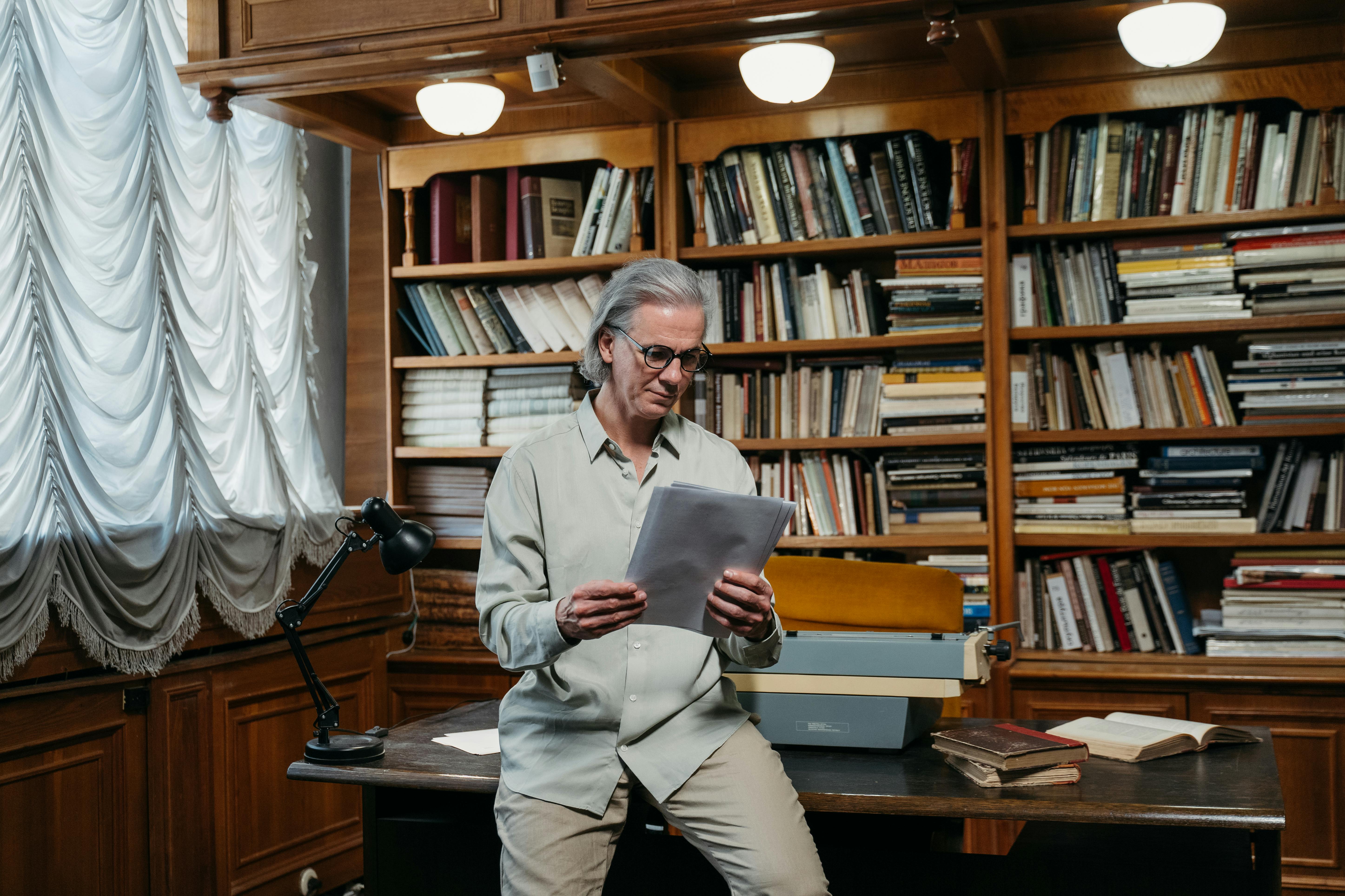 man in gray suit sitting on chair