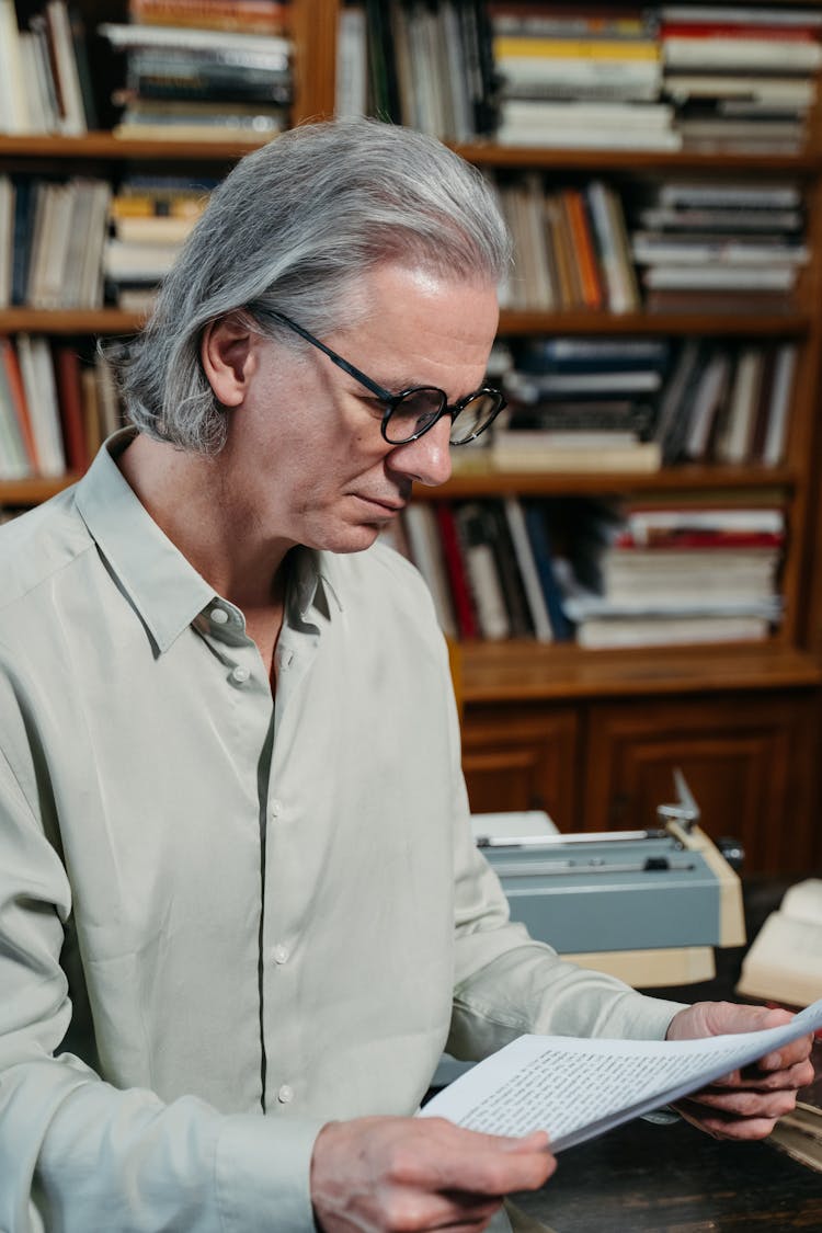 A Man Reading A Document