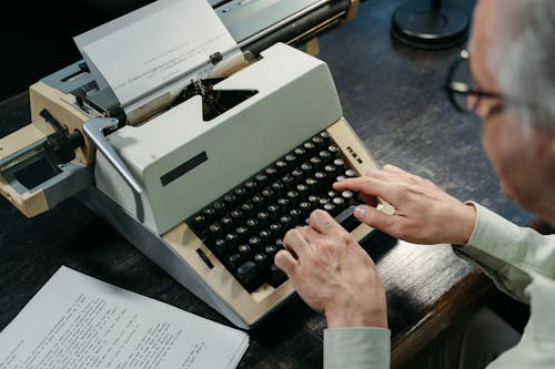 A Man Typing on the Typwriter