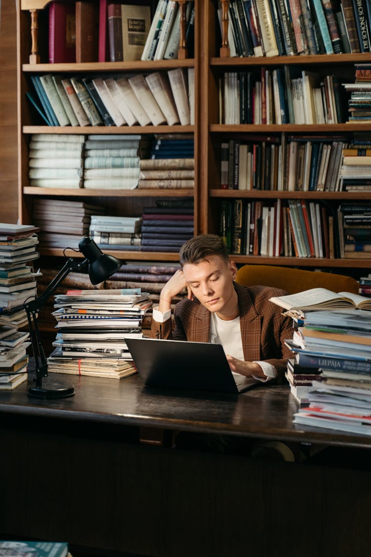 A Bored College Student Typing On Laptop