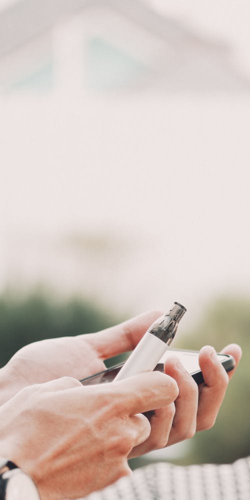 Free Person Holding an Electric Cigarette Stock Photo