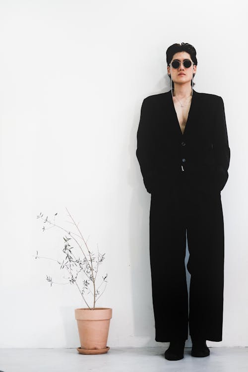 Man in Black Clothes and Plant on White Background