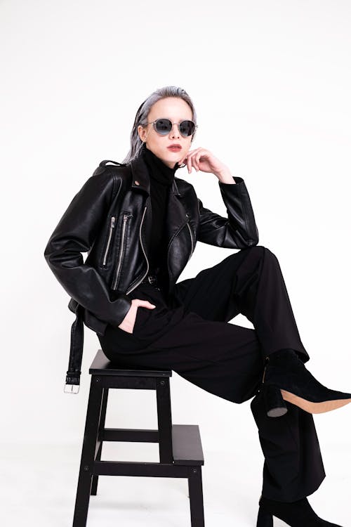 A Woman Wearing Black Leather Jacket and Black Pants