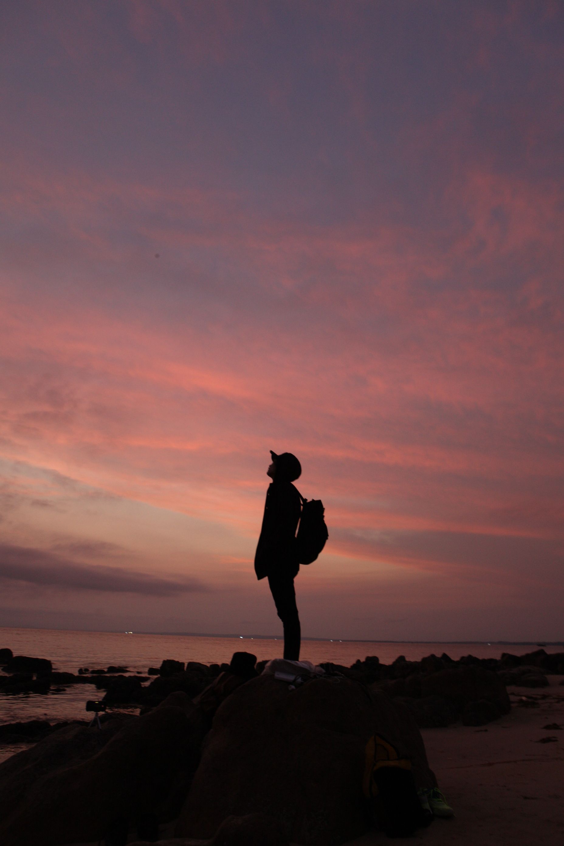 Silhouette of Man Standing on Rock during Sunset · Free Stock Photo