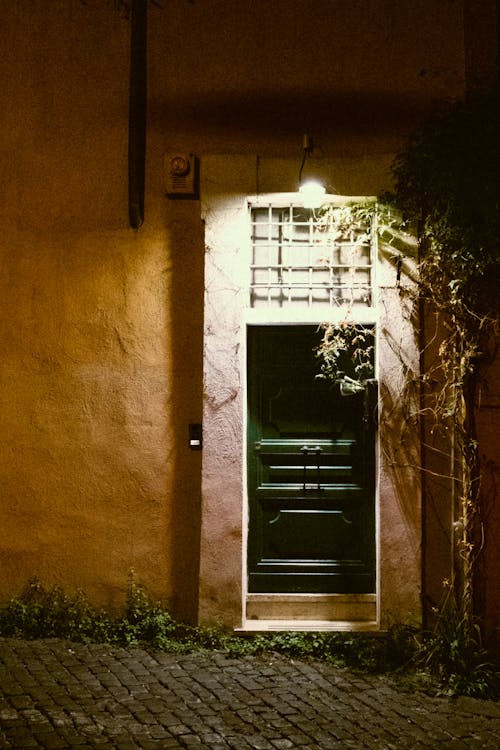 Brown Wooden Door on Brown Concrete Wall