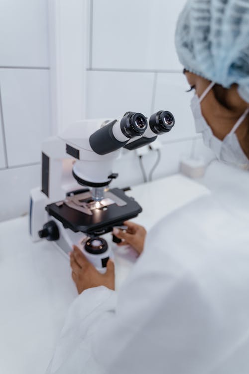 Medical Professional using Microscope 