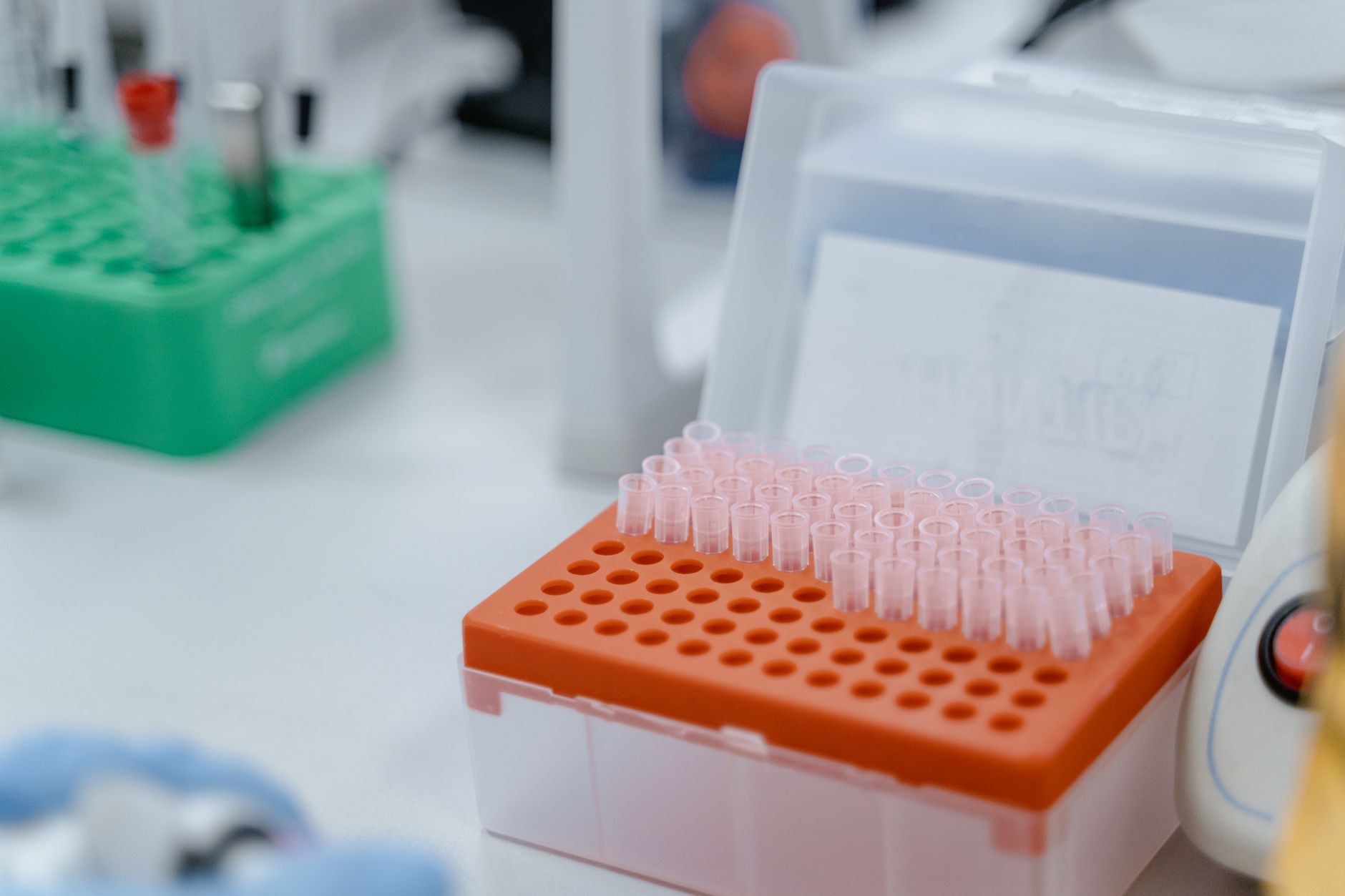 Close-up of laboratory equipment featuring test tube rack with scientific instruments.