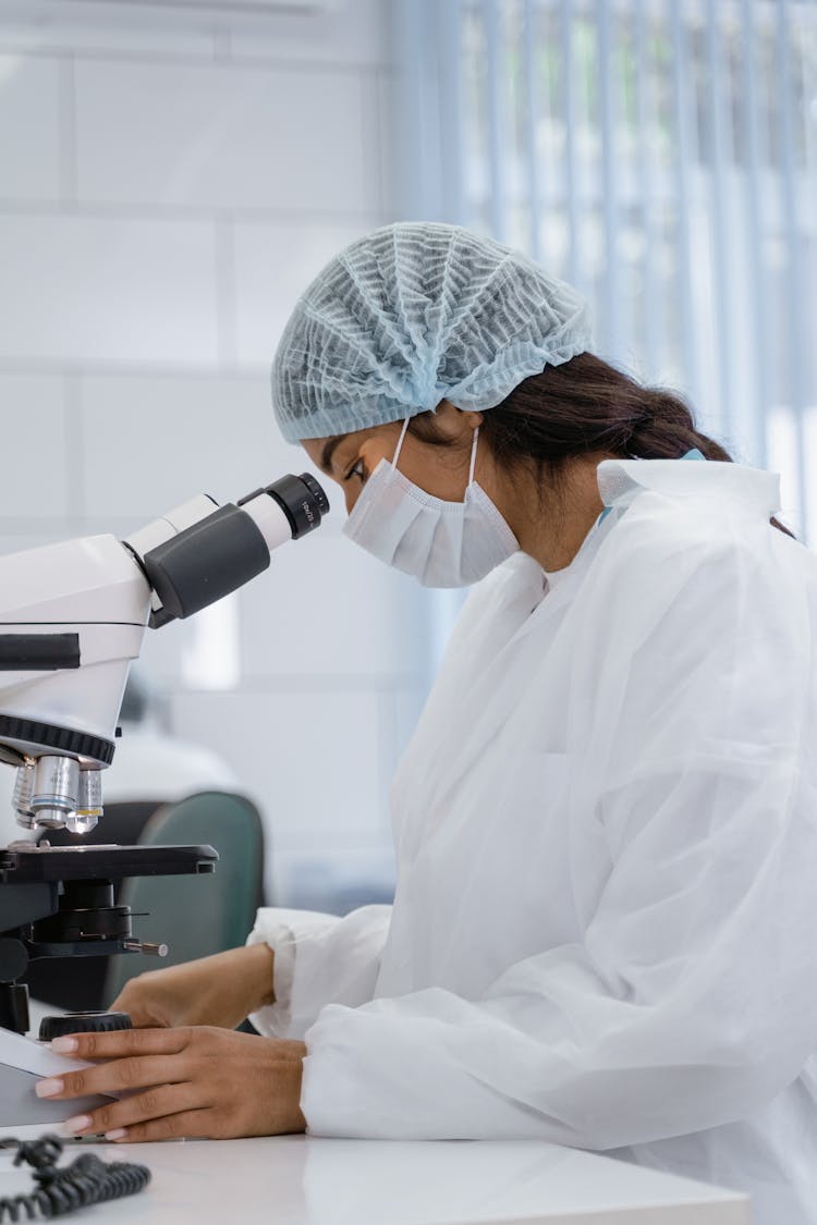 Medical Technologist Using A Microscope 