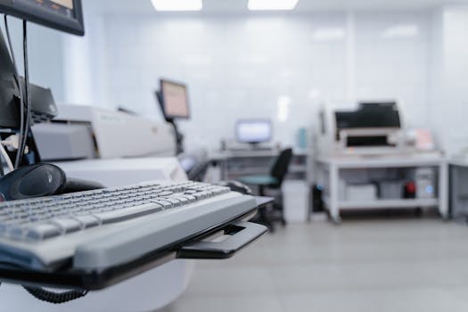 Close-up of sleek keyboard in a bright and modern laboratory setting.