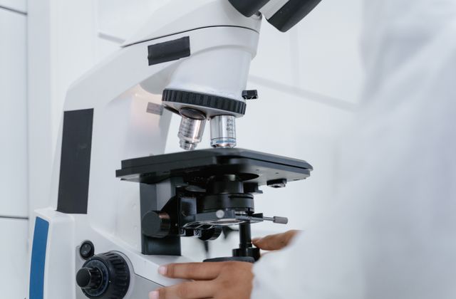 Scientist operating a microscope