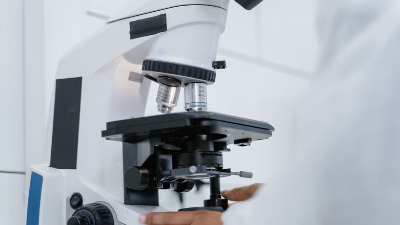 Scientist operating a microscope