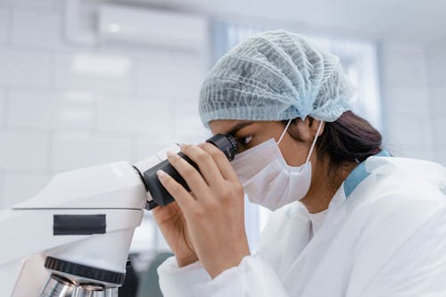 A Woman Using a Microscope