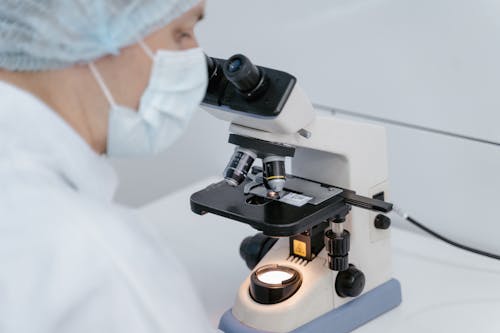 A Scientist Using Microscope