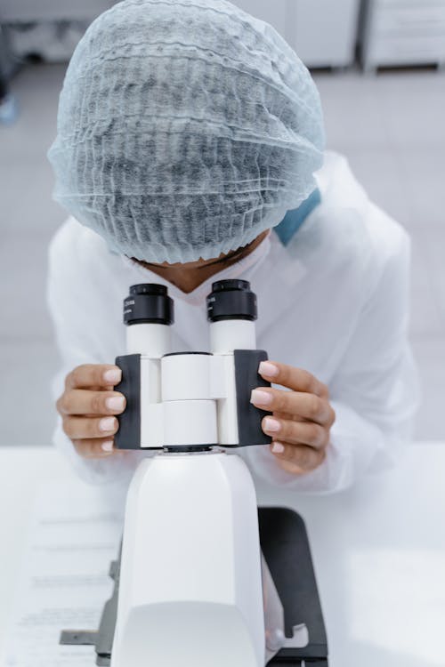 A Person Looking at the Microscope