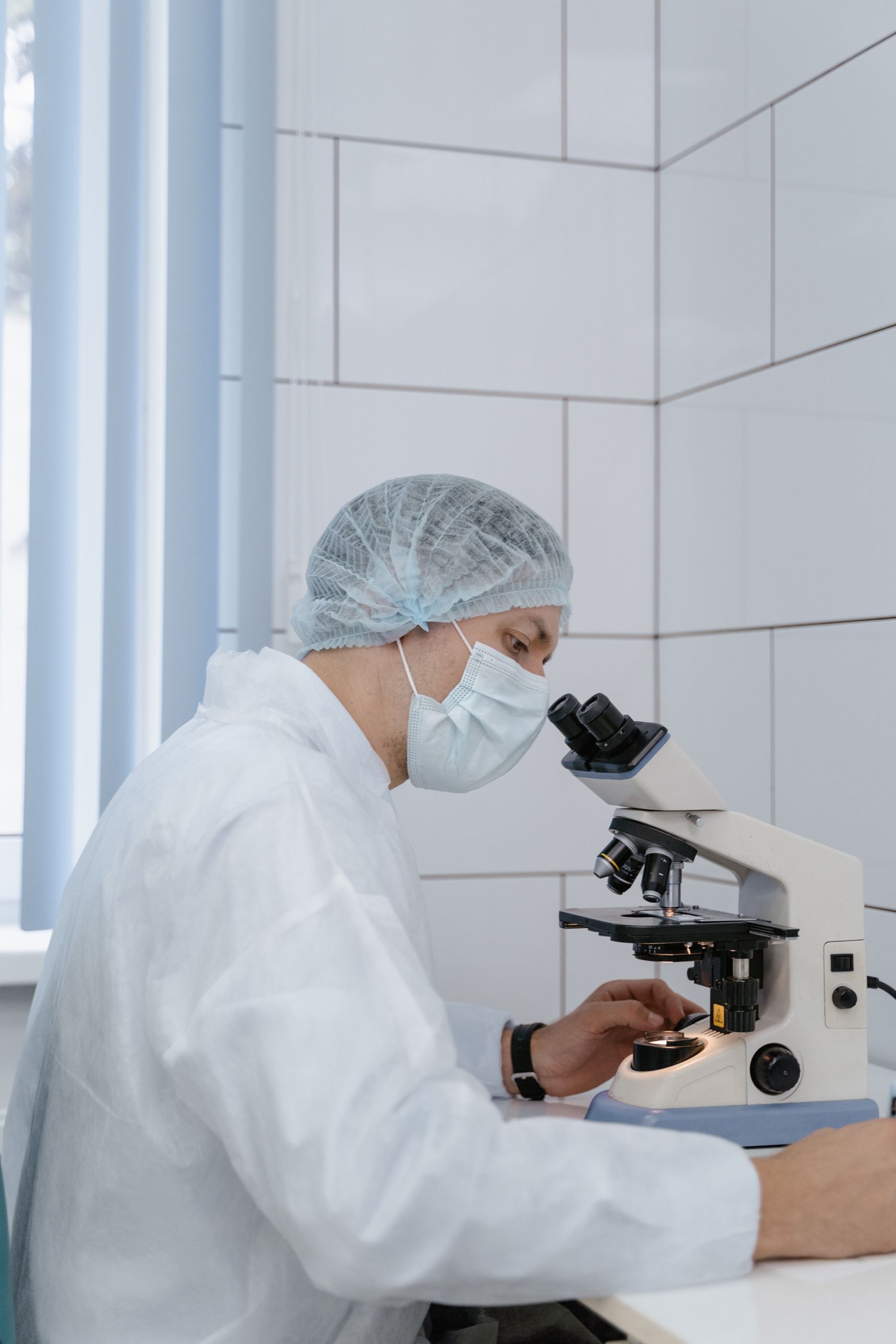 Scientist examining samples at a microscope