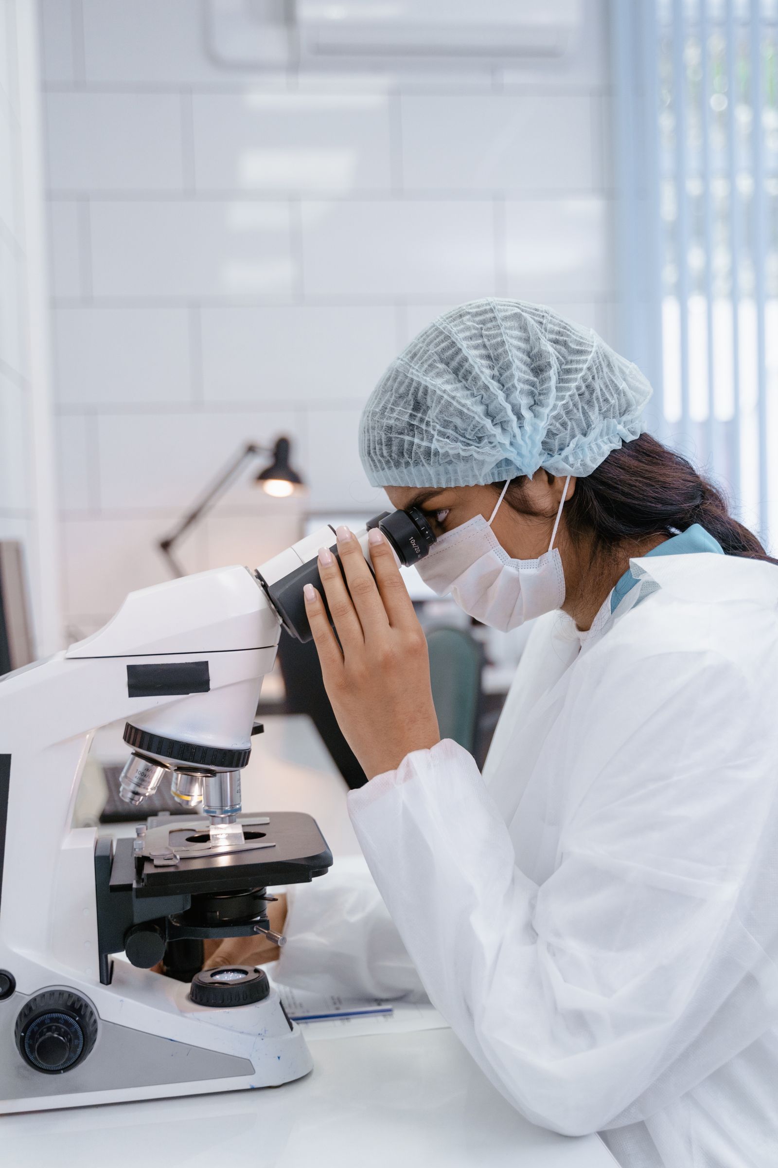 Female scientist using microscope