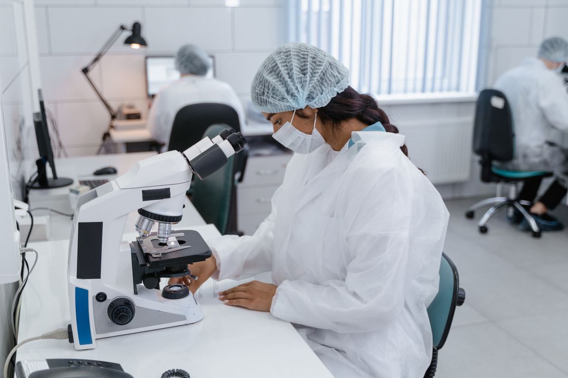 Medical Professional using Microscope · Free Stock Photo