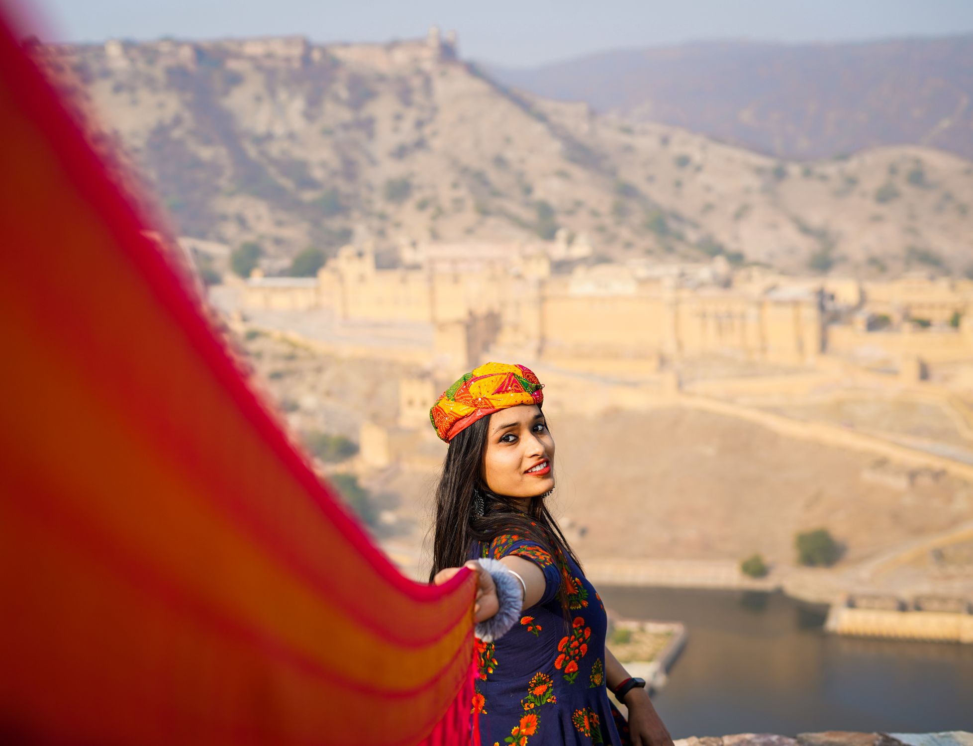 A woman in traditional attire at the iconic Amber Fort in Jaipur, India.