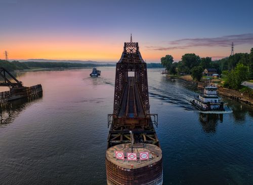 Free Aerial view of the Mississippi River and La Crescent Railroad Bridge in serene sunset light. Stock Photo