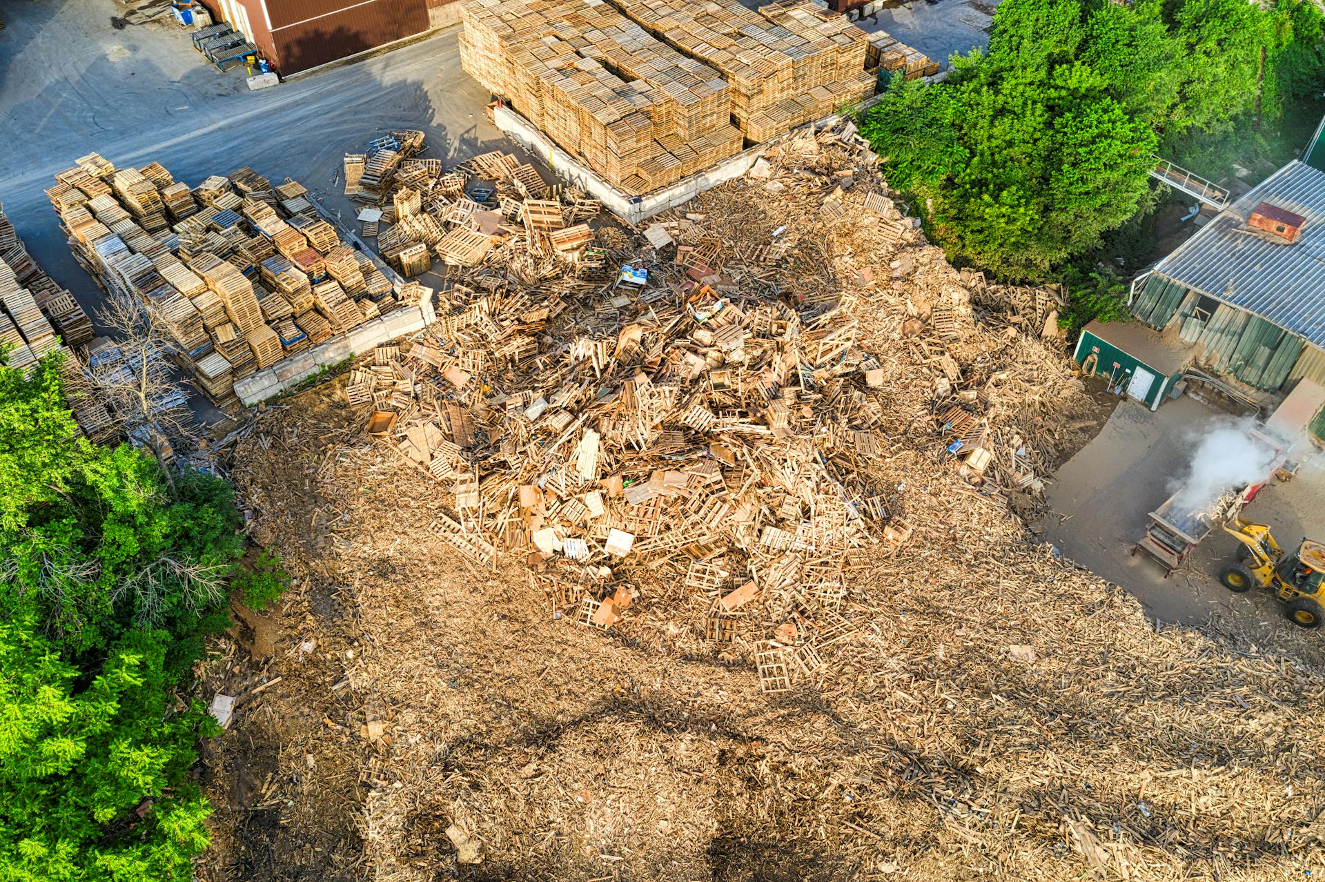 Aerial view of stacked wood pallets and waste in an industrial yard in Lake City, MN, USA.
