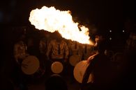 People Standing in Front of Fire during Nighttime