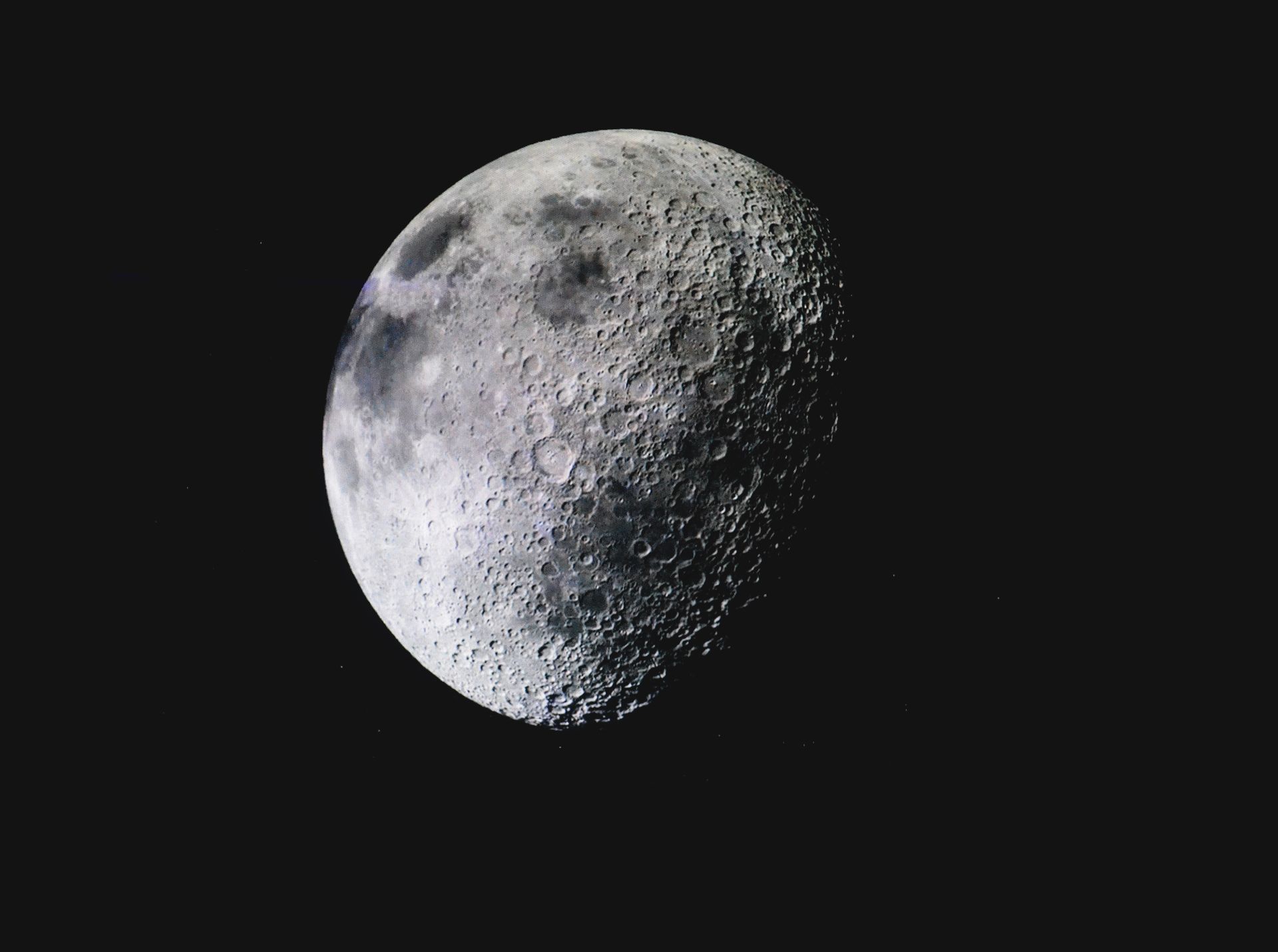 Captivating image of the lunar surface with visible craters against a deep dark sky.