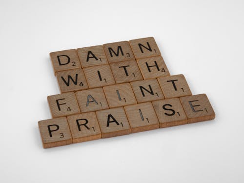 Close-Up Shot of Scrabble Tiles on White Surface