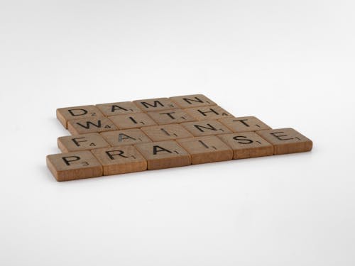 Free Brown Wooden Scrabble Tiles on White Background Stock Photo