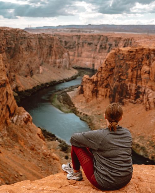 A Woman Sitting on a Cliff · Free Stock Photo