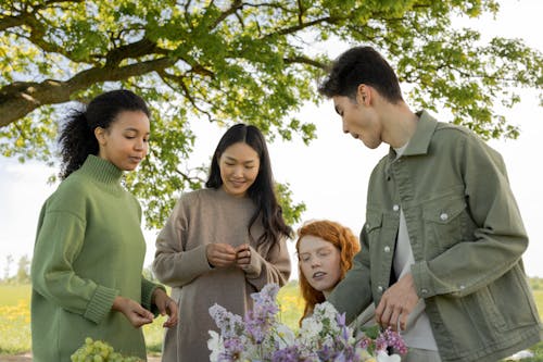Free Friends Chatting Under the Green Tree Stock Photo