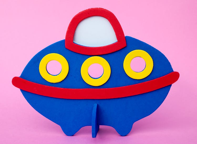 Blue Toy Spaceship On Pink Background