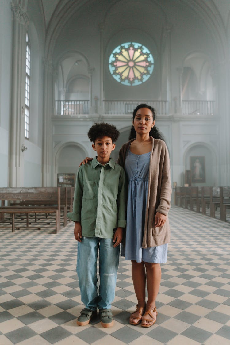 Mother And Son Standing Inside The Church